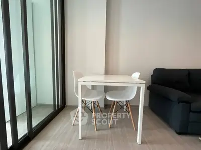 Modern living room with sleek dining area and glass doors