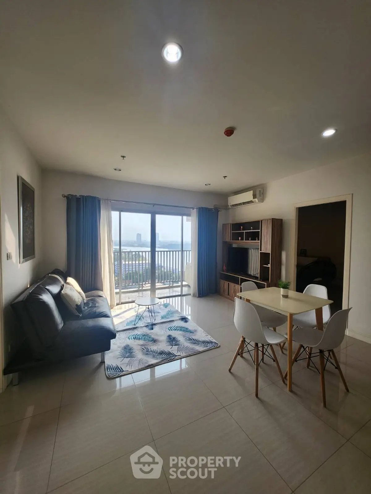 Spacious living room with modern furniture and balcony view