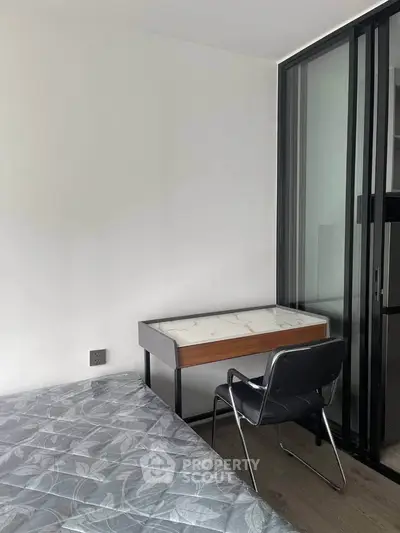 Modern bedroom with sleek study desk and comfortable chair