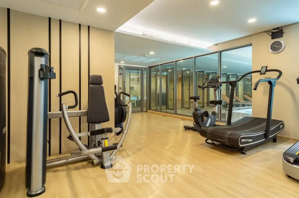 Modern gym with state-of-the-art fitness equipment in a luxury residential building.