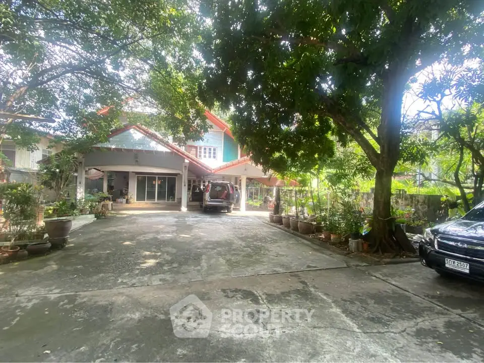 Charming suburban home with spacious driveway and lush greenery, perfect for family living.