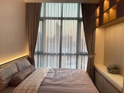 Cozy bedroom with large window and elegant curtains, perfect for relaxation and comfort.