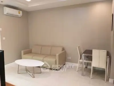 Modern living room with beige sofa, white coffee table, and dining set.