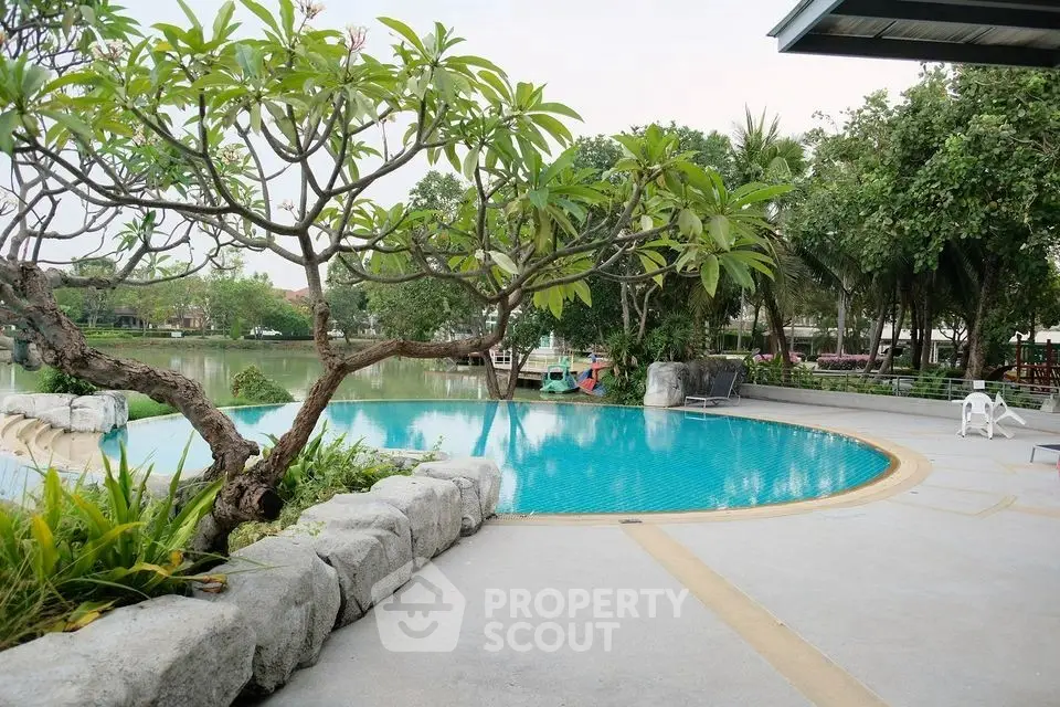 Luxurious poolside view with lush greenery and serene ambiance