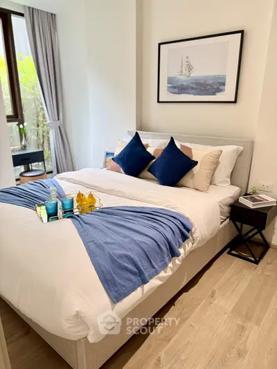 Elegant bedroom with stylish decor and natural light, featuring a cozy bed and modern furnishings.