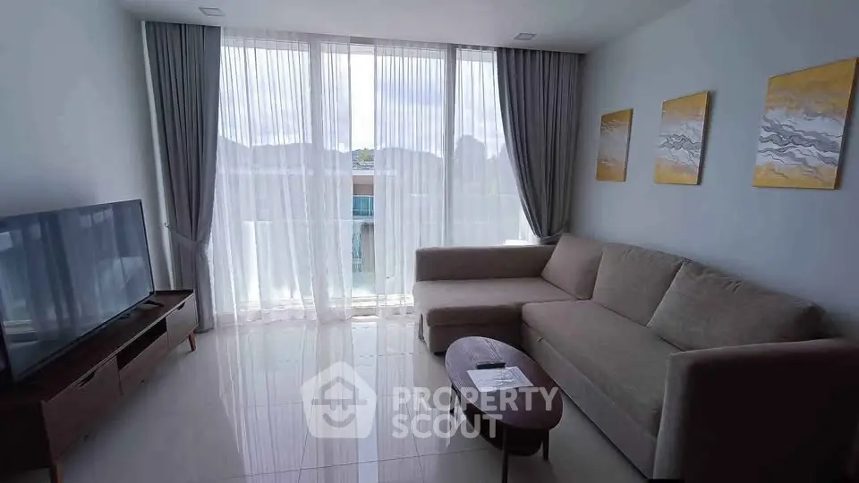 Spacious living room with modern sofa and large window view