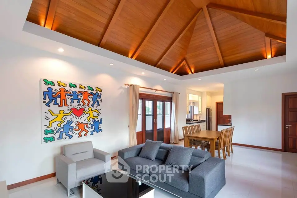 Spacious living room with high wooden ceiling and modern decor