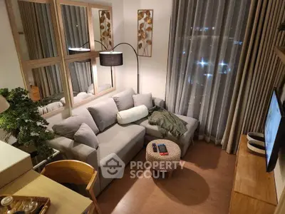Cozy modern living room with stylish decor and city view, perfect for relaxation and entertainment.