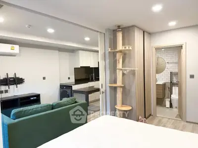 Modern studio apartment with open layout, featuring a cozy living area, compact kitchen, and stylish bathroom.