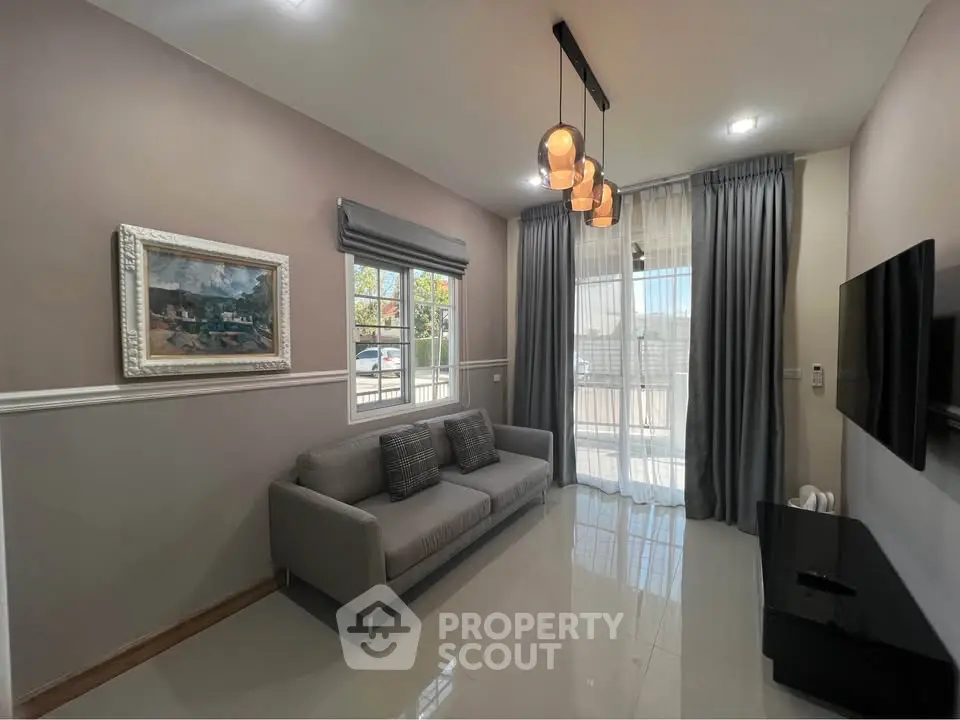 Modern living room with sleek design, large window, and stylish lighting.