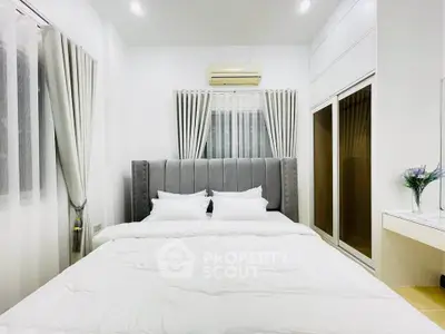 Modern bedroom with elegant decor and ample natural light