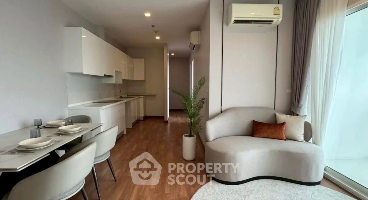 Modern living room with sleek furniture and open kitchen layout