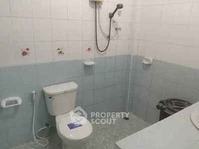 Spacious bathroom with modern fixtures and tiled walls, ideal for comfort and convenience.