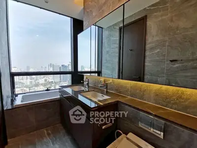 Luxurious bathroom with city view, modern fixtures, and elegant design in high-rise apartment.