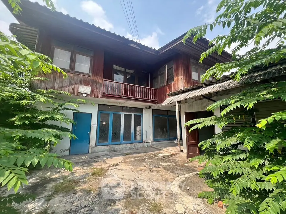 Charming rustic wooden house with lush greenery and spacious courtyard