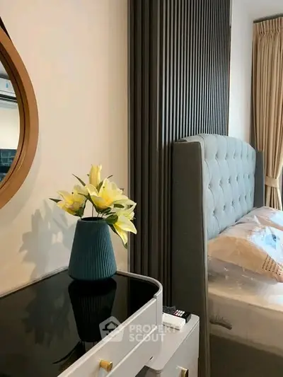 Stylish bedroom with modern decor and elegant furnishings, featuring a plush bed and chic side table.