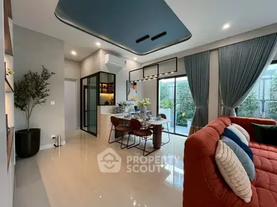 Modern open-plan living and dining area with stylish decor and garden view.