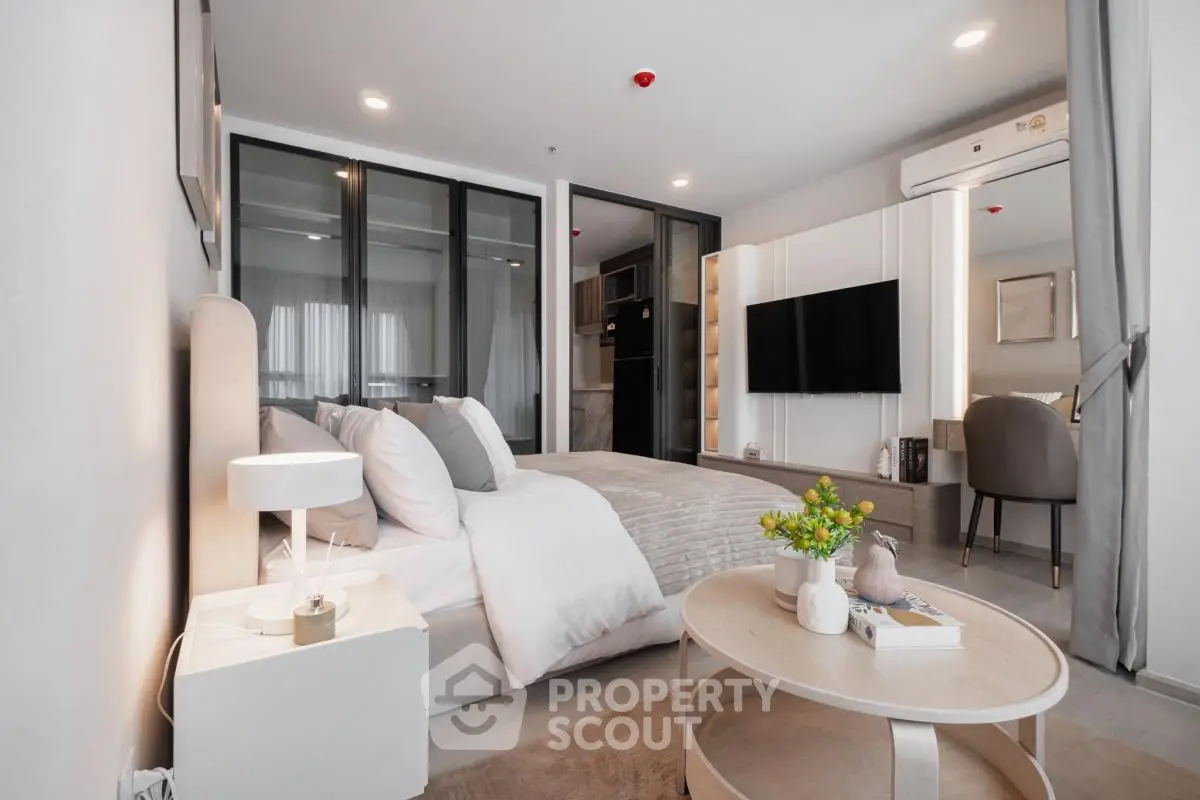 Modern bedroom with stylish decor and cozy ambiance in a contemporary apartment.