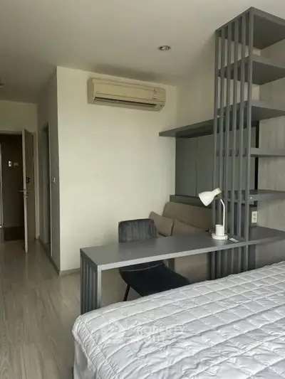 Modern bedroom with sleek desk and air conditioning, ideal for comfortable living.