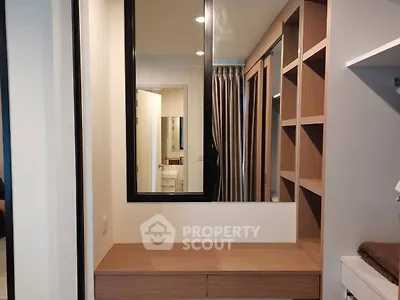Modern bedroom with built-in wooden shelves and mirror, perfect for stylish storage solutions.