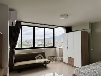 Spacious corner unit bedroom with panoramic city view and modern furnishings.