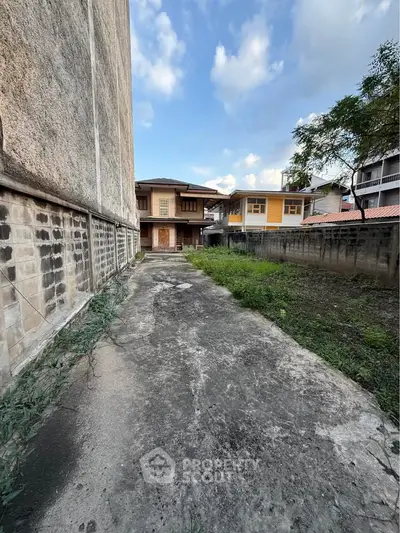 Spacious outdoor area with potential for landscaping in urban residential setting.