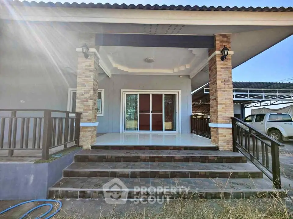 Charming modern house entrance with elegant stone pillars and spacious porch