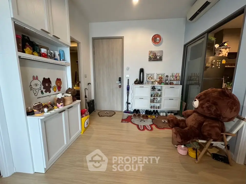 Charming entryway with playful decor and plush bear in cozy apartment