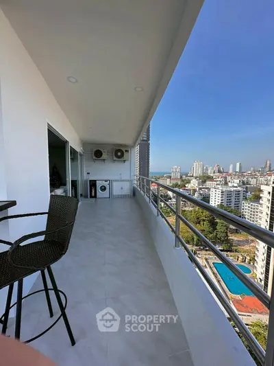 Spacious balcony with stunning city view and modern seating area.