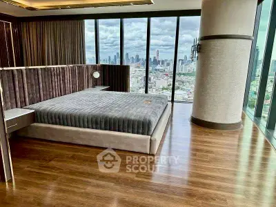 Luxurious bedroom with panoramic city view and elegant wooden flooring.