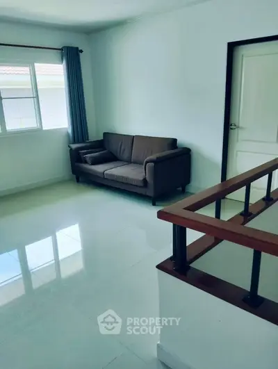 Bright living room with modern sofa and large window, perfect for relaxation.