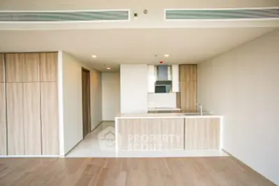 Modern open kitchen with sleek wooden cabinetry and minimalist design
