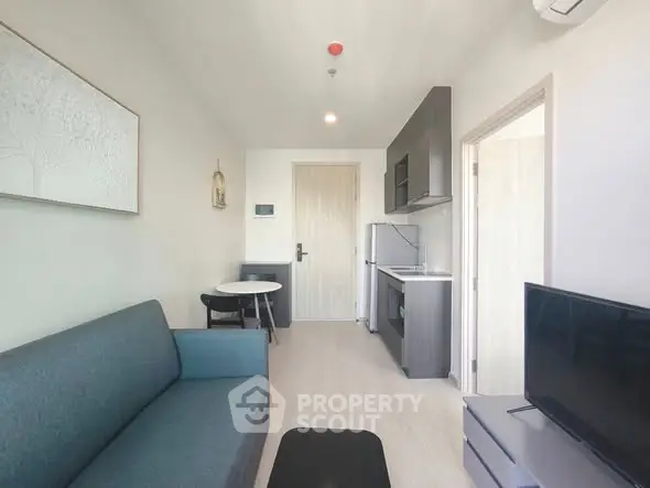 Modern living room with sleek furniture and compact kitchen area