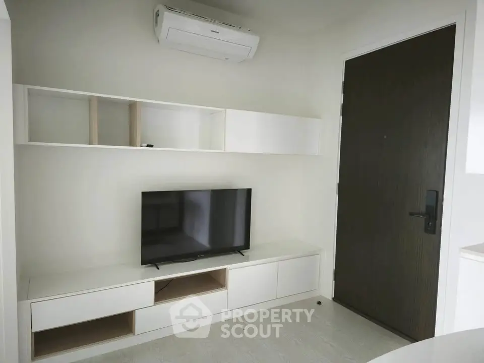 Modern living room with sleek TV unit and air conditioning, perfect for contemporary urban living.