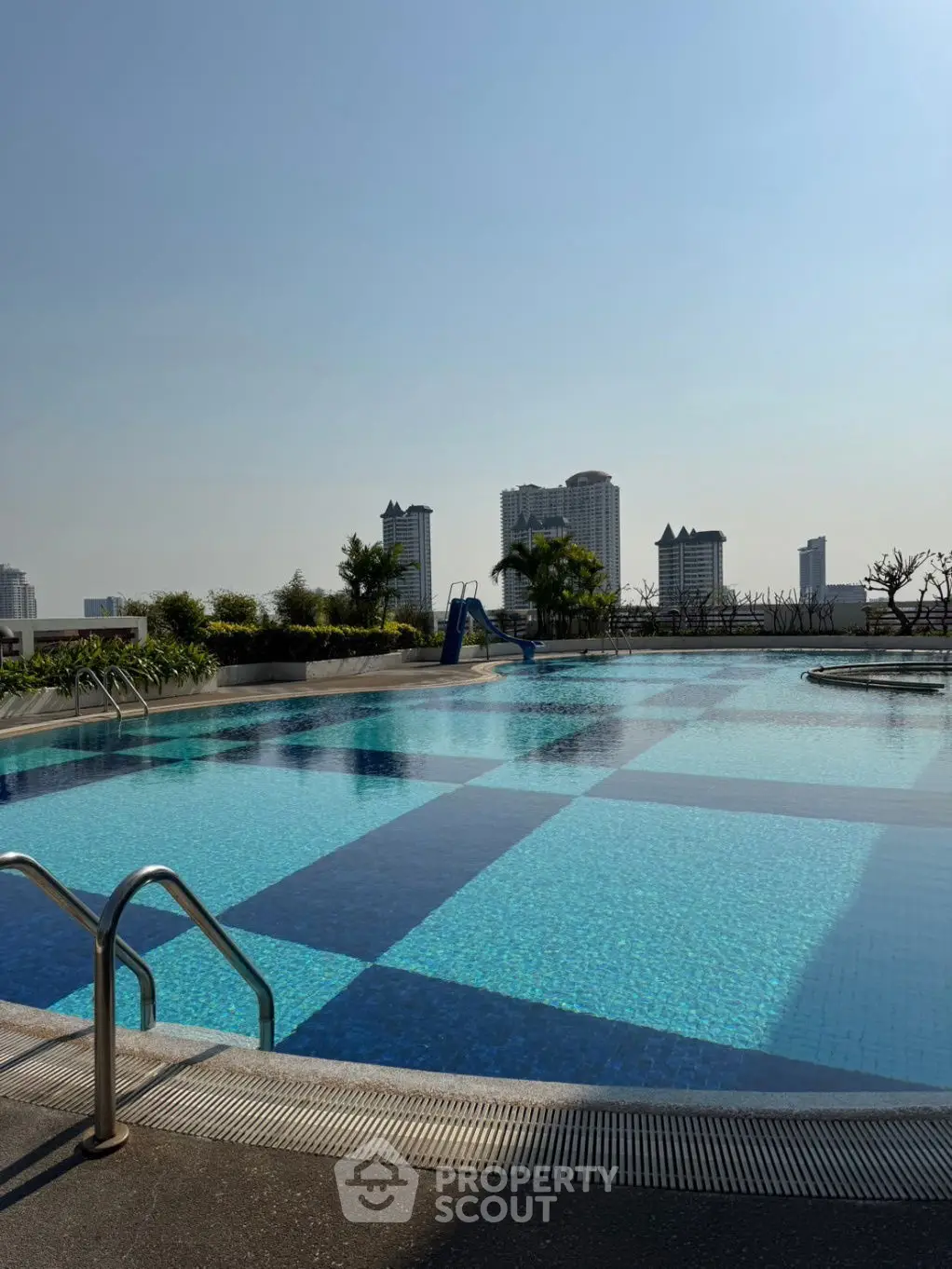 Luxurious rooftop pool with stunning city skyline views, perfect for relaxation and leisure.