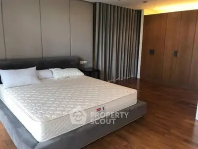 Spacious bedroom with modern design and wooden flooring