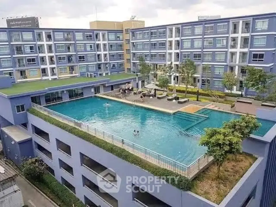 Luxurious rooftop pool with modern apartment building view, perfect for relaxation and leisure.