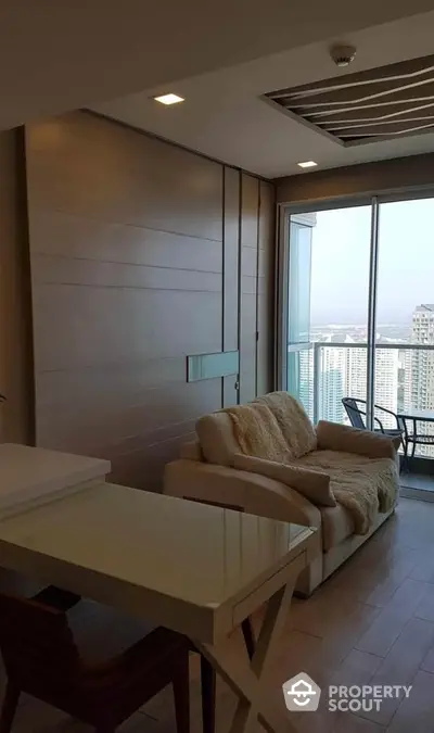 Modern living room with balcony and city view in high-rise apartment