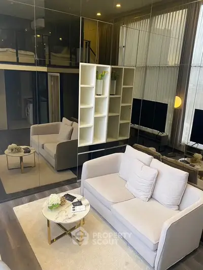 Modern living room with loft, mirrored walls, and elegant furniture in a stylish apartment.
