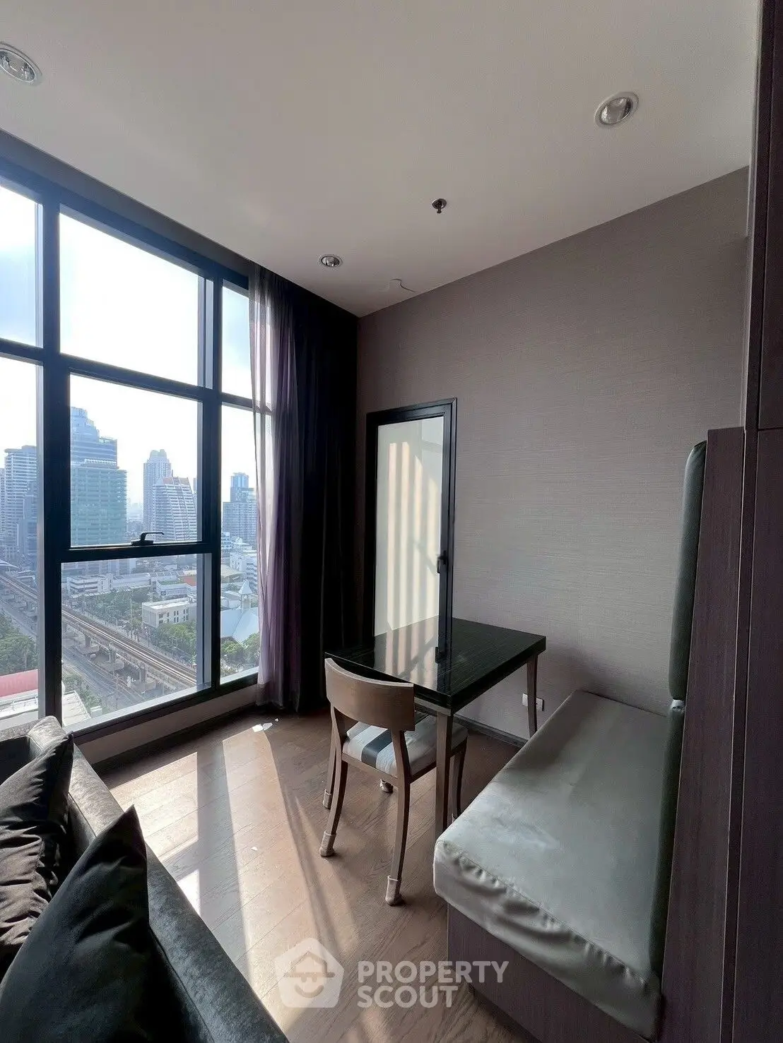 Modern high-rise apartment with stunning city view and stylish interior design.