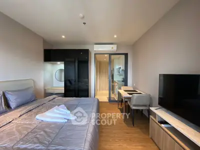 Modern bedroom with sleek design, featuring a cozy bed, stylish furniture, and a flat-screen TV.