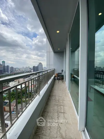Spacious balcony with stunning city skyline view, perfect for relaxation and enjoying urban living.