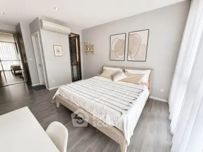 Modern bedroom with stylish decor and natural light, featuring a comfortable bed and minimalist design.
