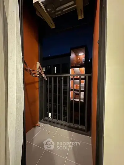 Cozy balcony with night view of modern building exterior