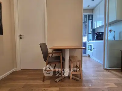 Cozy kitchen with wooden flooring and compact dining area