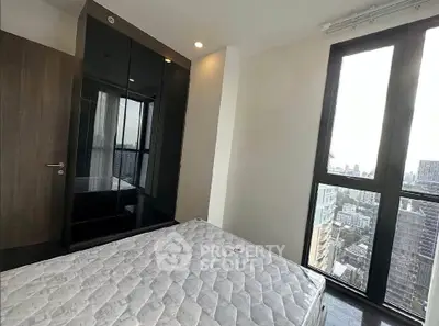 Modern bedroom with city view and sleek wardrobe