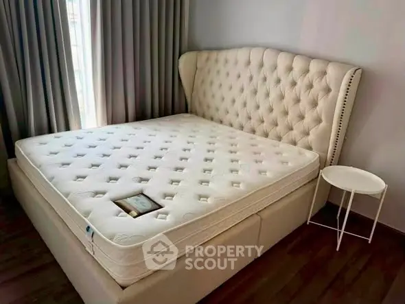 Luxurious bedroom with elegant tufted headboard and plush mattress, perfect for restful nights.