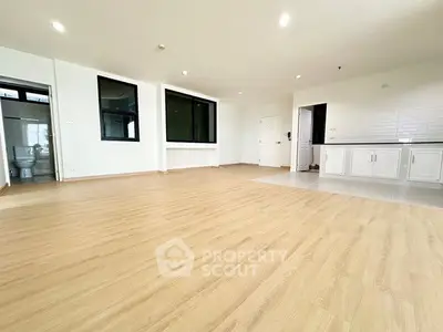 Spacious open-plan living area with modern kitchen and wooden flooring
