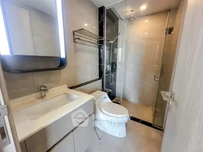 Modern bathroom with sleek fixtures and glass shower enclosure
