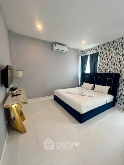 Modern bedroom with stylish decor and air conditioning in a contemporary apartment.